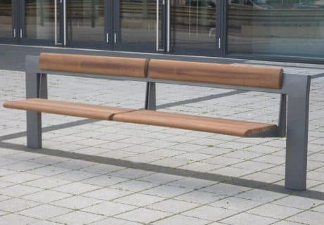 Eine freistehende Holzsitzbank am Wegesrand