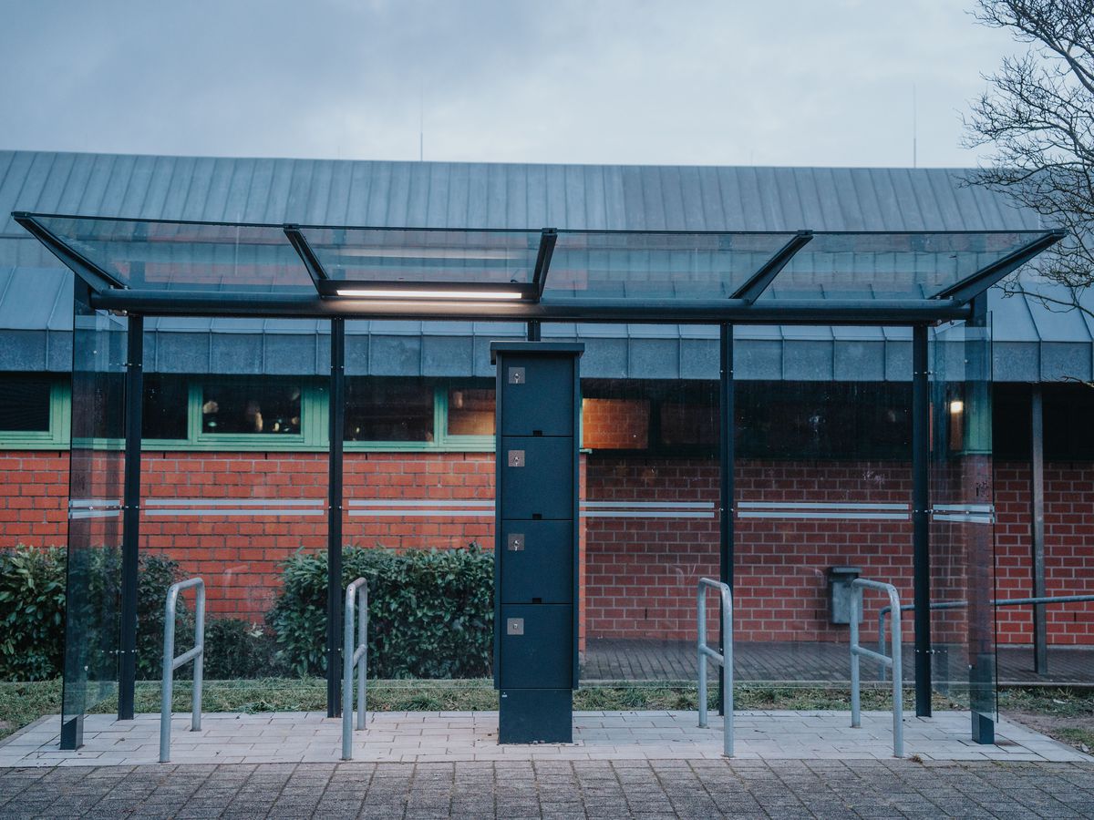 Eine Wartehalle mit E-Bike-Ladestation und Fahrradanlehnbügeln